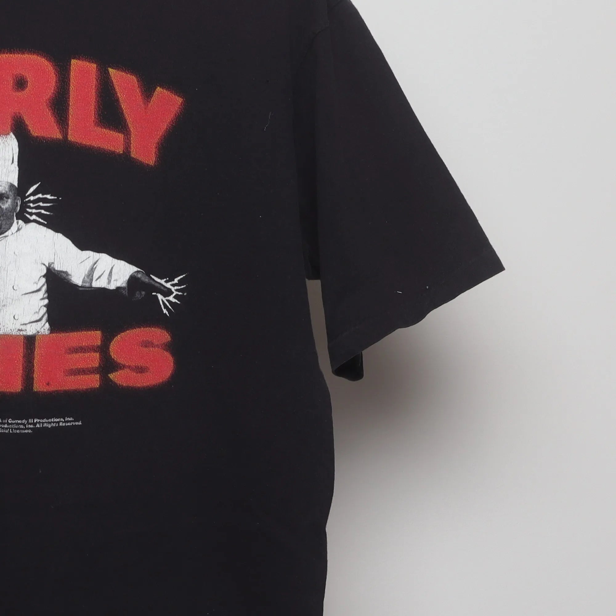 Close-up of the sleeve on the Vintage 90s Curly Fries Promo Graphic T-Shirt XL