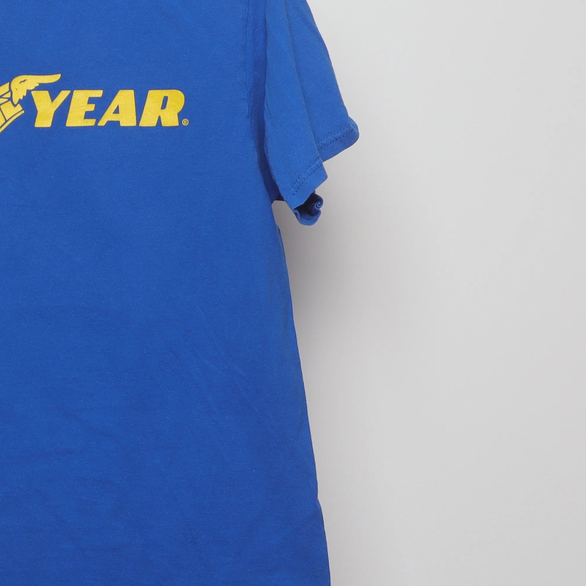 Close-up of the sleeve on the Vintage 90s Goodyear Winged Foot Logo T-Shirt S