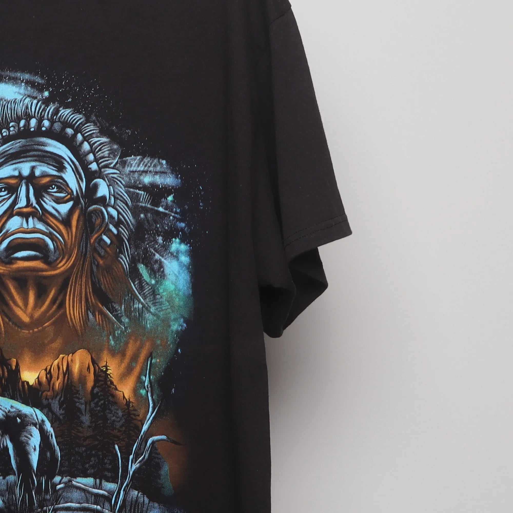 Close-up of the sleeve on the Vintage 90s Howling Wolf Native Chief Graphic T-Shirt L