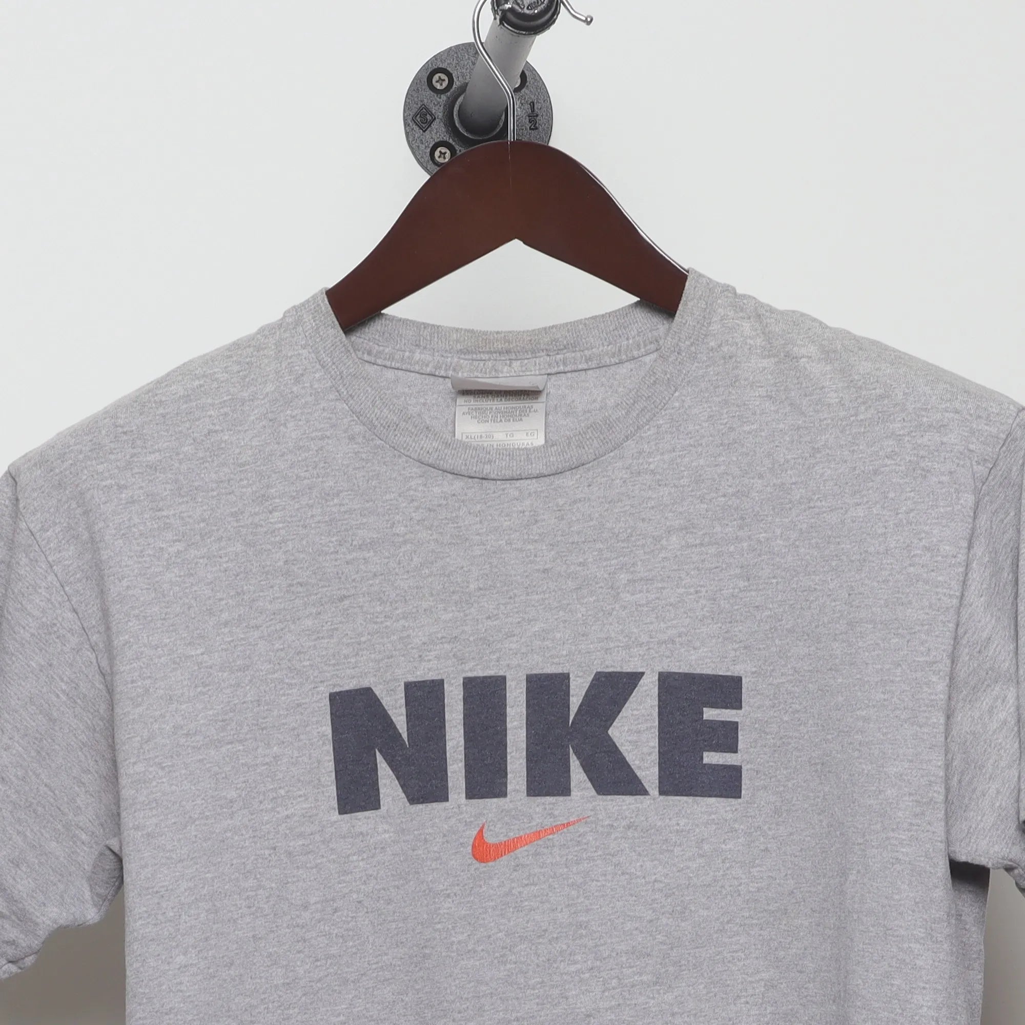 Close-up of the collar and tag on the Vintage 90s Nike Block Logo Swoosh T-Shirt M