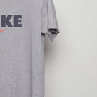 Close-up of the sleeve on the Vintage 90s Nike Block Logo Swoosh T-Shirt M