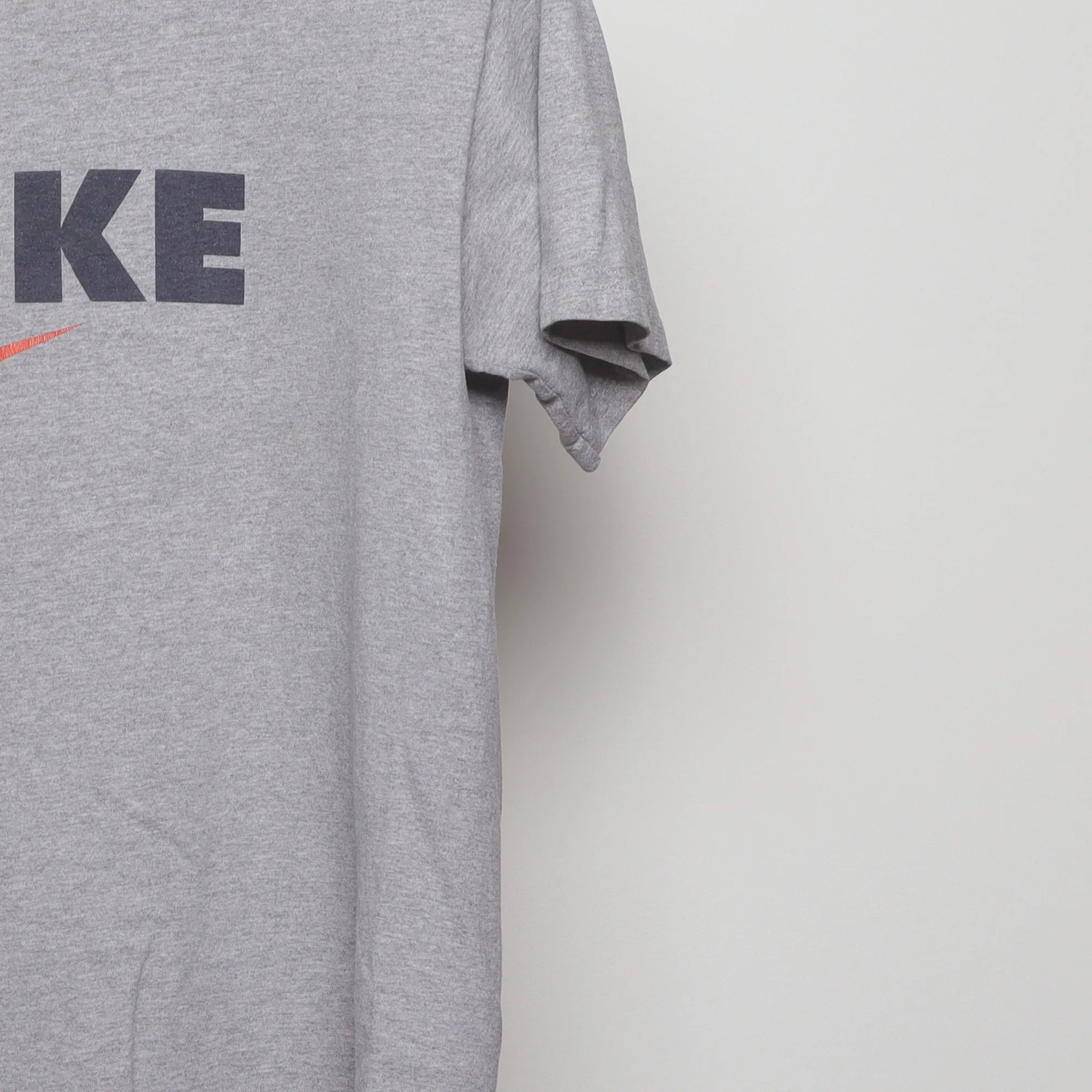 Close-up of the sleeve on the Vintage 90s Nike Block Logo Swoosh T-Shirt M