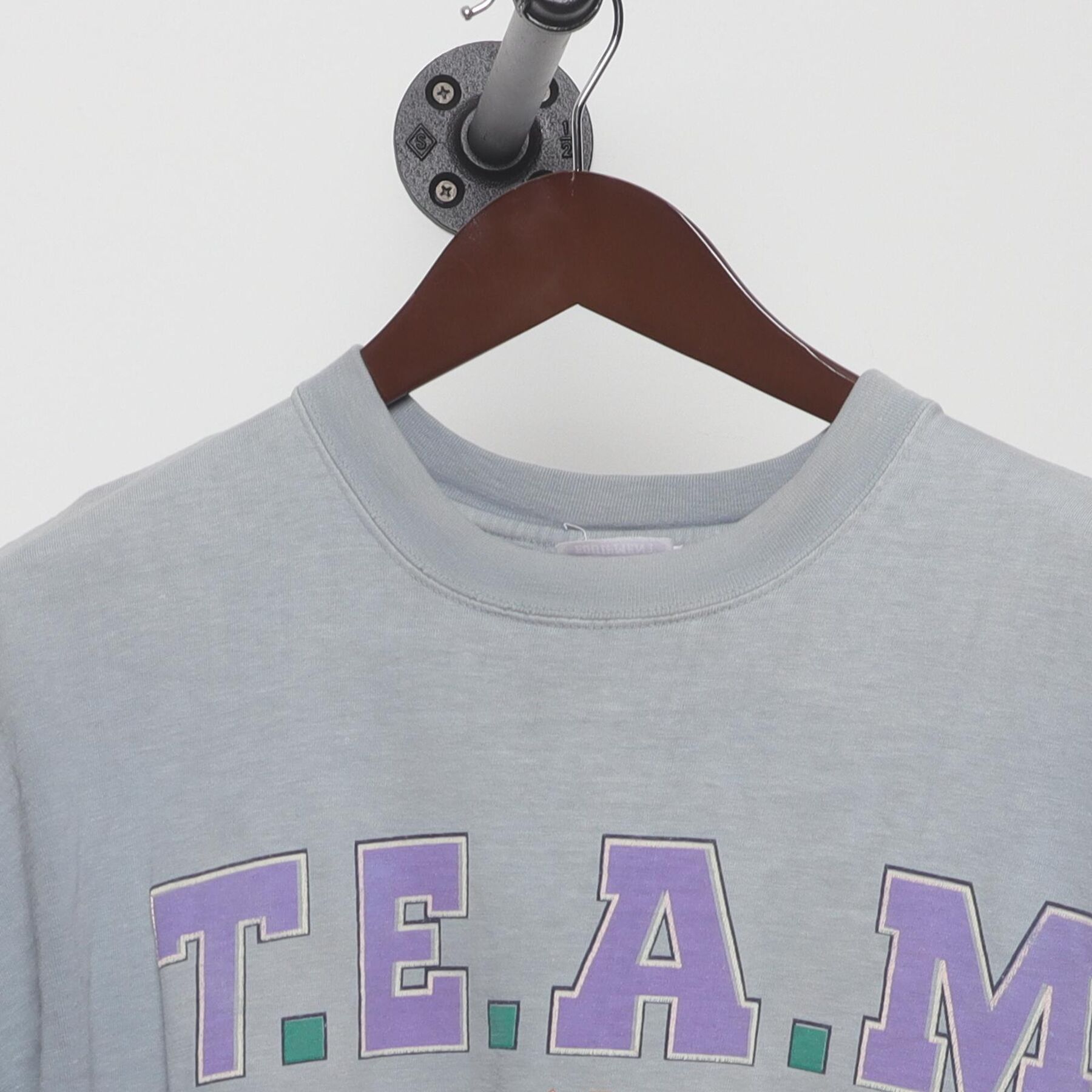 Close-up of the collar and tag on the Vintage 1990s T.E.A.M. "Athletic Equipment" T-Shirt - XL
