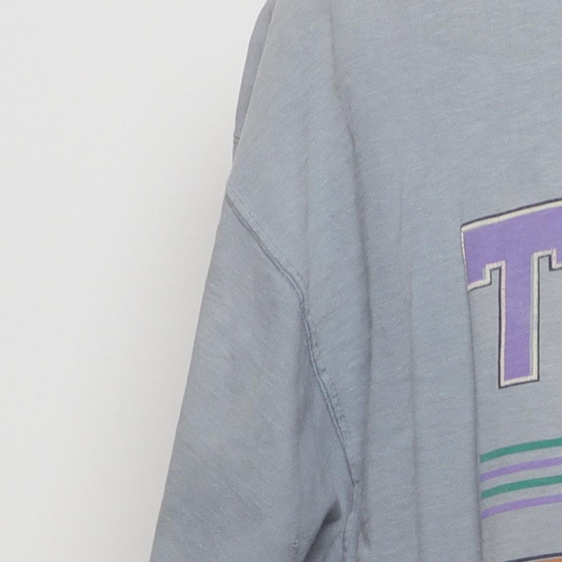 Close-up of the Left sleeve on the Vintage 1990s T.E.A.M. "Athletic Equipment" T-Shirt - XL