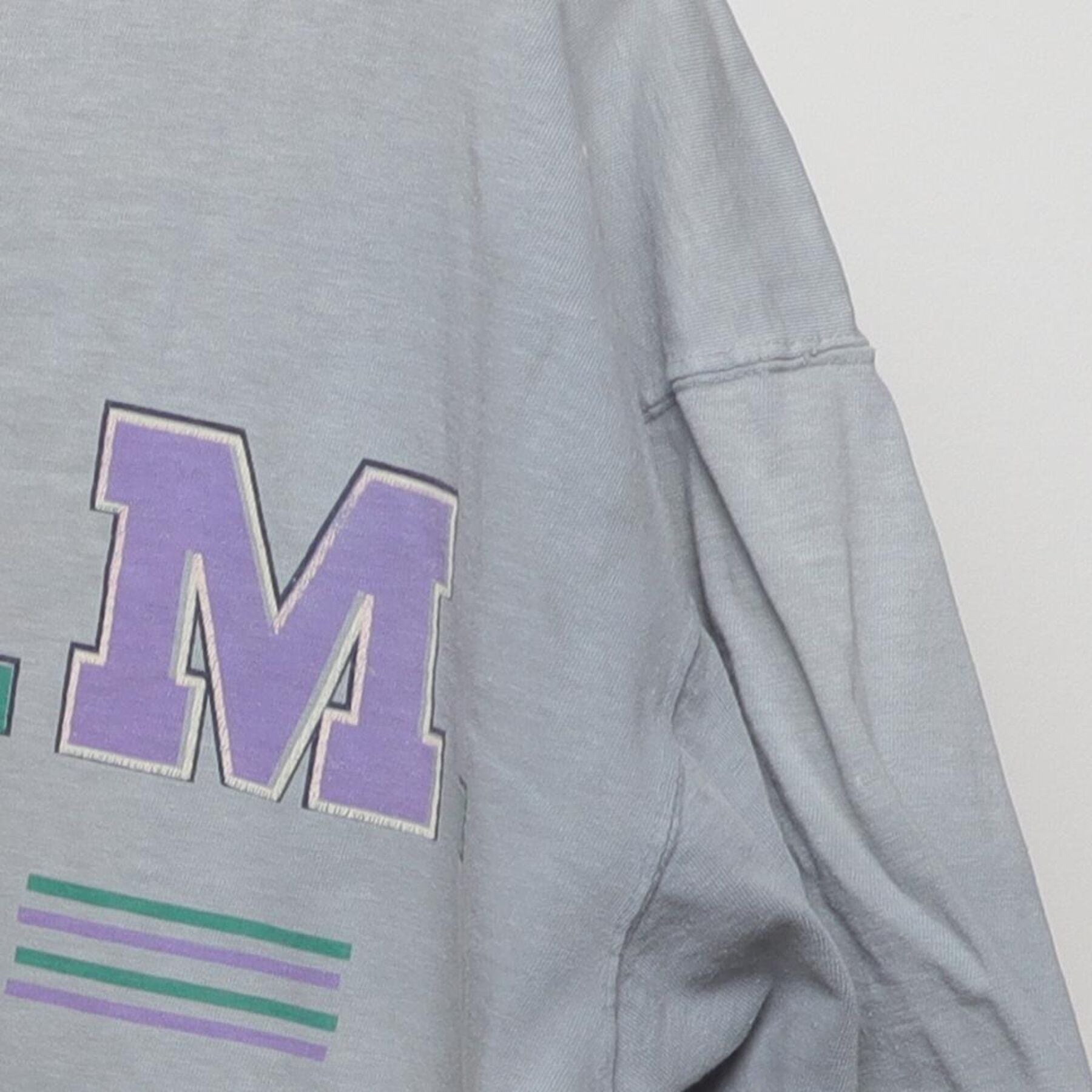 Close-up of the Right sleeve on the Vintage 1990s T.E.A.M. "Athletic Equipment" T-Shirt - XL