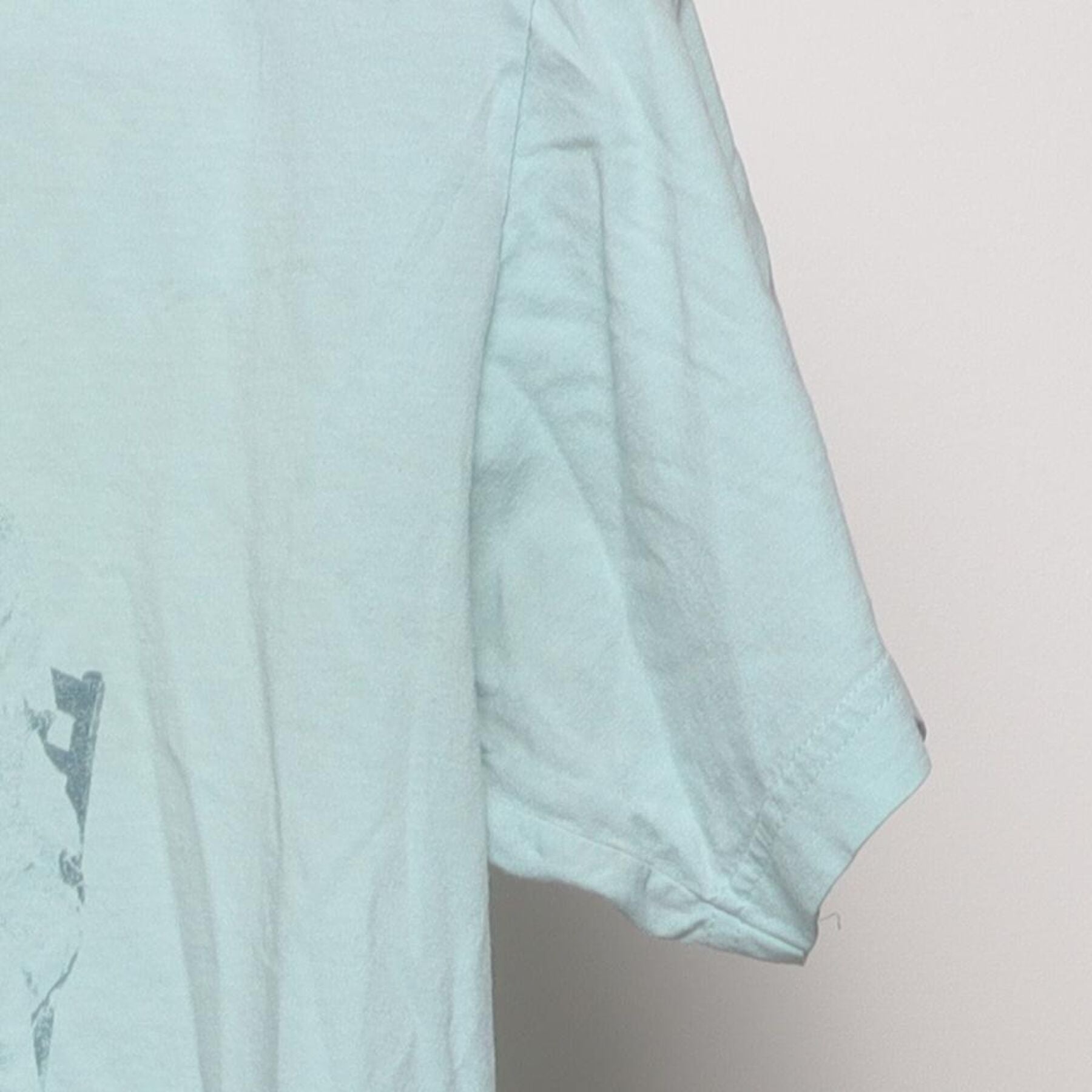 Close-up of the Right sleeve on the Vintage Y2K Ben & Jerry's "Founders Portrait" T-Shirt - S