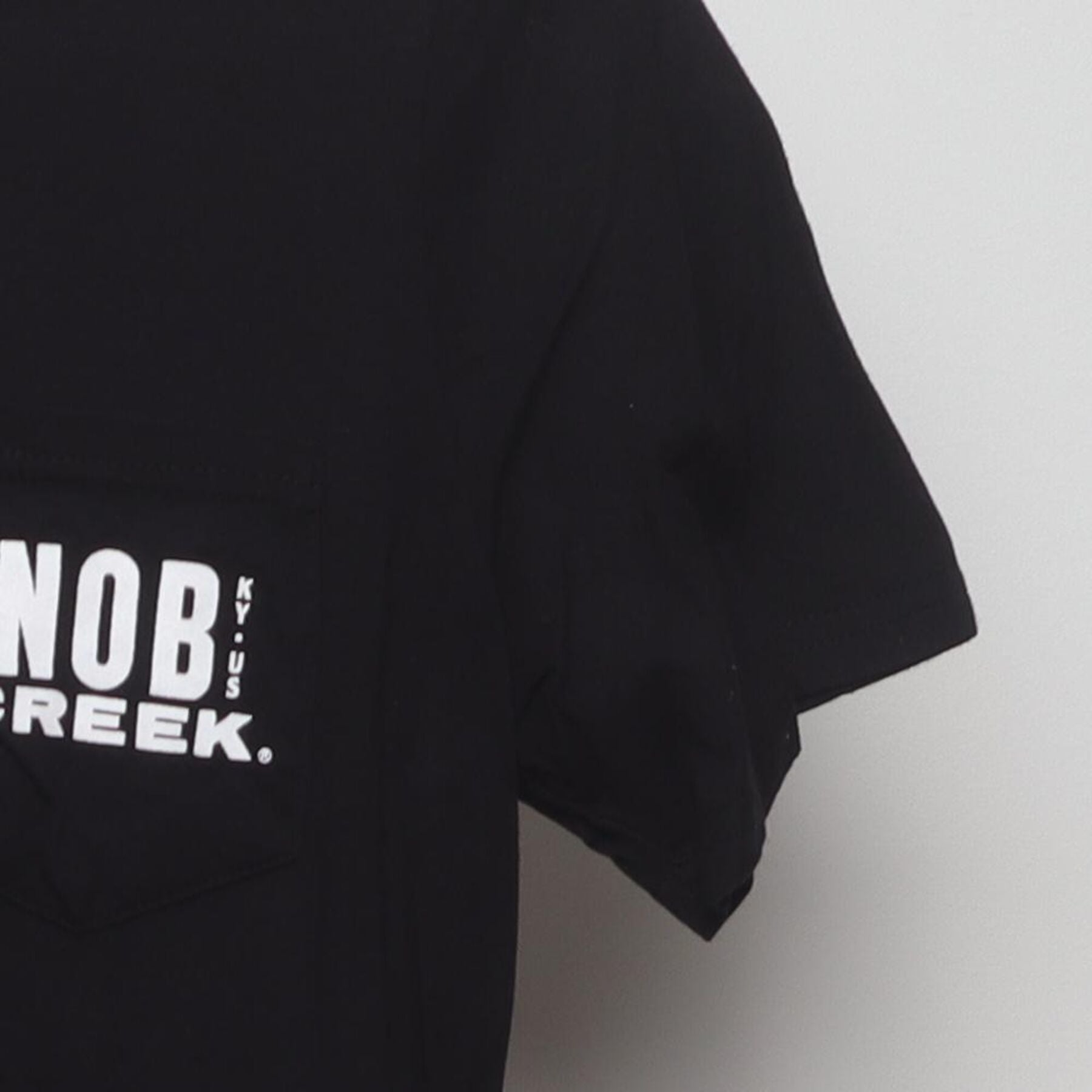 Close-up of the Right sleeve on the Vintage Y2K Knob Creek "Every Bit Earned" T-Shirt - XS