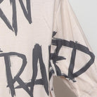 Close-up of the sleeve on the Vintage Modern "Born to Lose Raised to Win" T-Shirt - L
