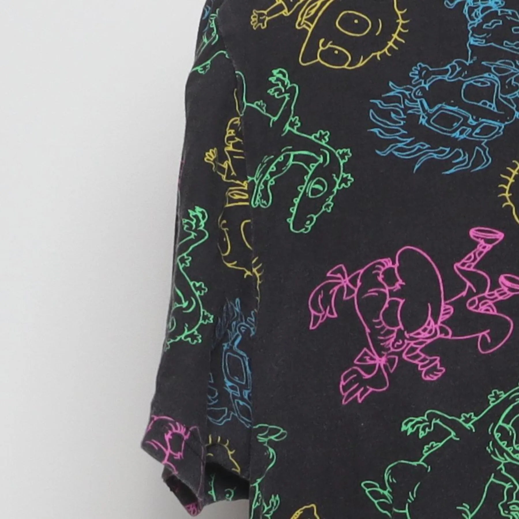 Close-up of the Left sleeve on the Vintage Y2K Nickelodeon "Rugrats Neon AOP" T-Shirt - M
