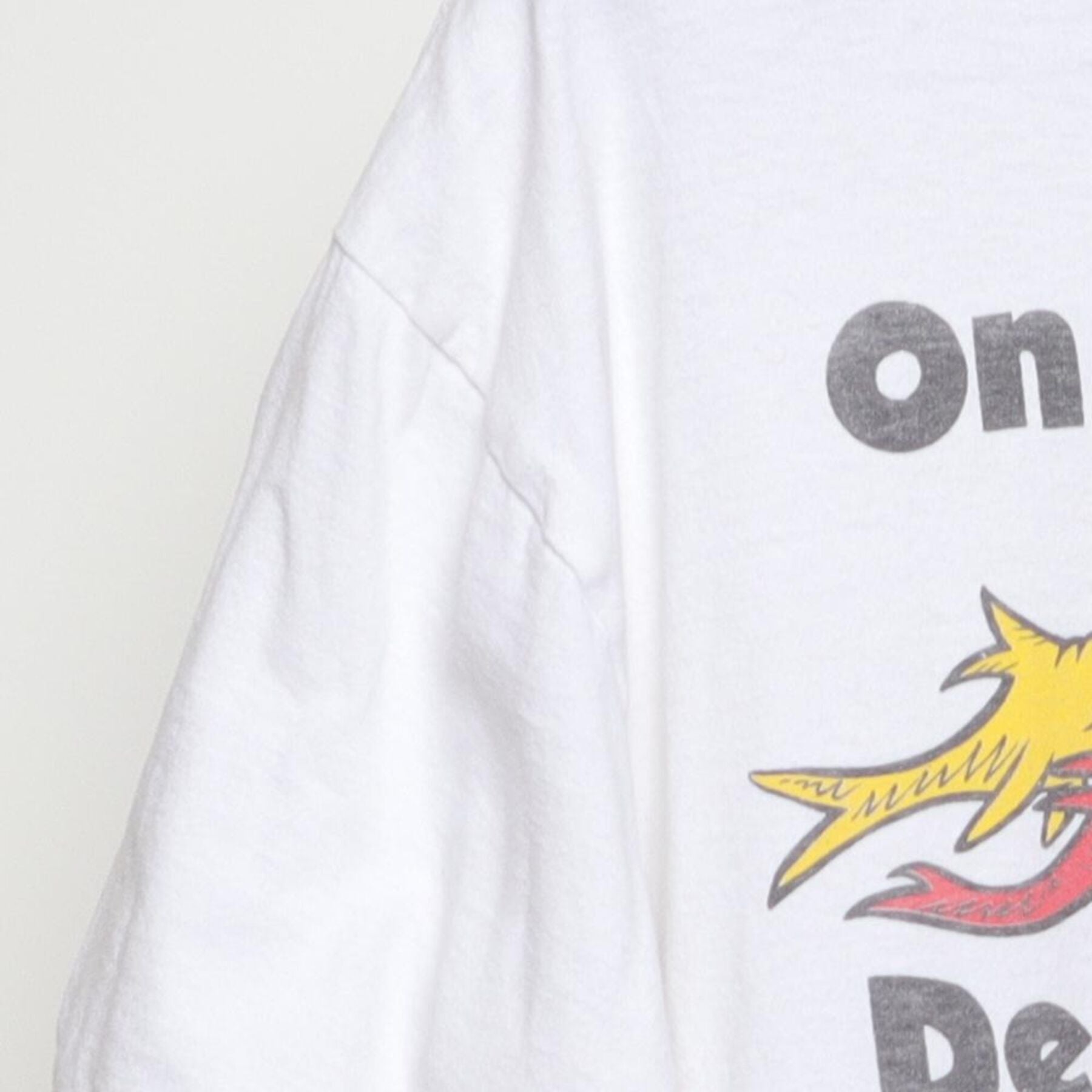 Close-up of the Left sleeve on the Vintage Y2K Phish "One Fish Two Fish Dead Fish Newphish" T-Shirt - L