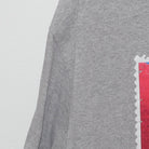 Close-up of the Left sleeve on the Vintage Y2K Royal Caribbean "Cuba Souvenir Stamp" T-Shirt - M