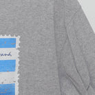 Close-up of the Right sleeve on the Vintage Y2K Royal Caribbean "Cuba Souvenir Stamp" T-Shirt - M