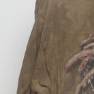 Close-up of the Left sleeve on the Vintage Y2K The Mountain "Reggae Lion" T-Shirt - XL