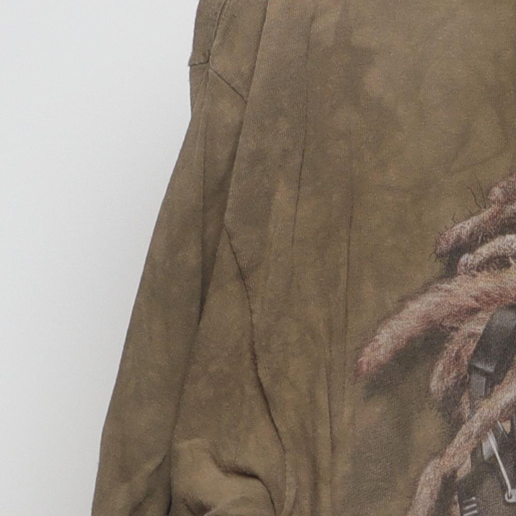 Close-up of the Left sleeve on the Vintage Y2K The Mountain "Reggae Lion" T-Shirt - XL