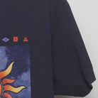 Close-up of the sleeve on the Vintage Y2K Anvil "Celestial Sun & Moon" T-Shirt - L