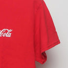 Close-up of the sleeve on the Vintage Y2K Coca-Cola "Classic Script Logo" T-Shirt - M