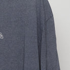 Close-up of the Right sleeve on the Vintage Y2K Unleash Break "Tribal Logo" T-Shirt - L