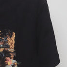 Close-up of the sleeve on the Vintage Y2K Marc Ecko "Lost in Wonderland" T-Shirt - L