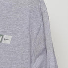 Close-up of the sleeve on the Vintage Y2K Nike "Athletics Engineered for Performance" T-Shirt - L