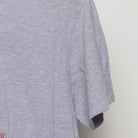 Close-up of the sleeve on the Vintage Y2K Purina "Checkerboard Logo" T-Shirt - M