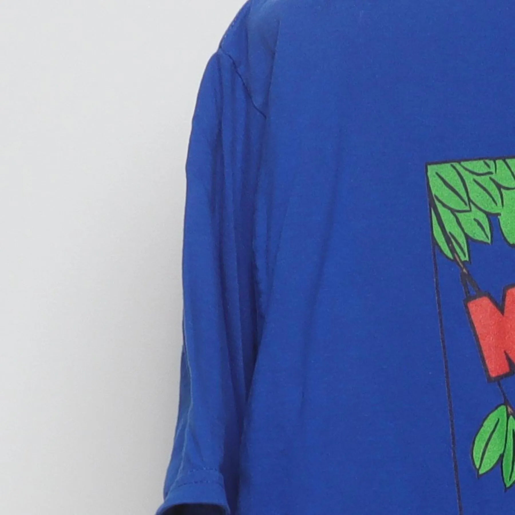 Close-up of the Left sleeve on the Vintage 2000s Disney "Mickey Mouse The Band Concert" T-Shirt - L